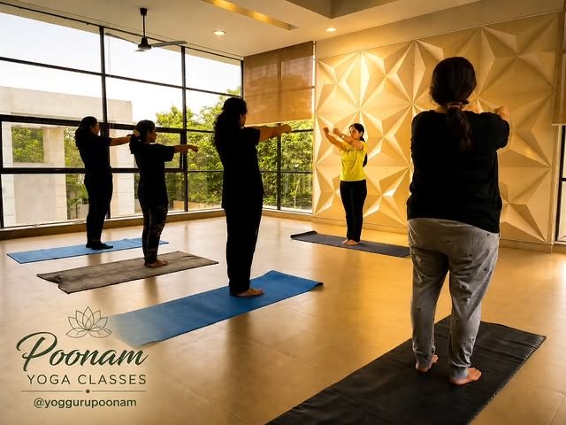 A group class practising a standing arm-stretch sequence in a sunlit studio